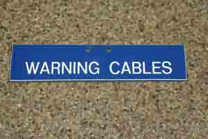 Sign - [WARNING CABLES] 200 X 49MM TRAFFOLYTE PLATE WITH PREDRILLED HOLE X2 BACKGROUND = BLUE LETTERING = WHITE